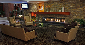 Large stone fireplace and comfortable chairs in a lounge at the High Country Conference Center